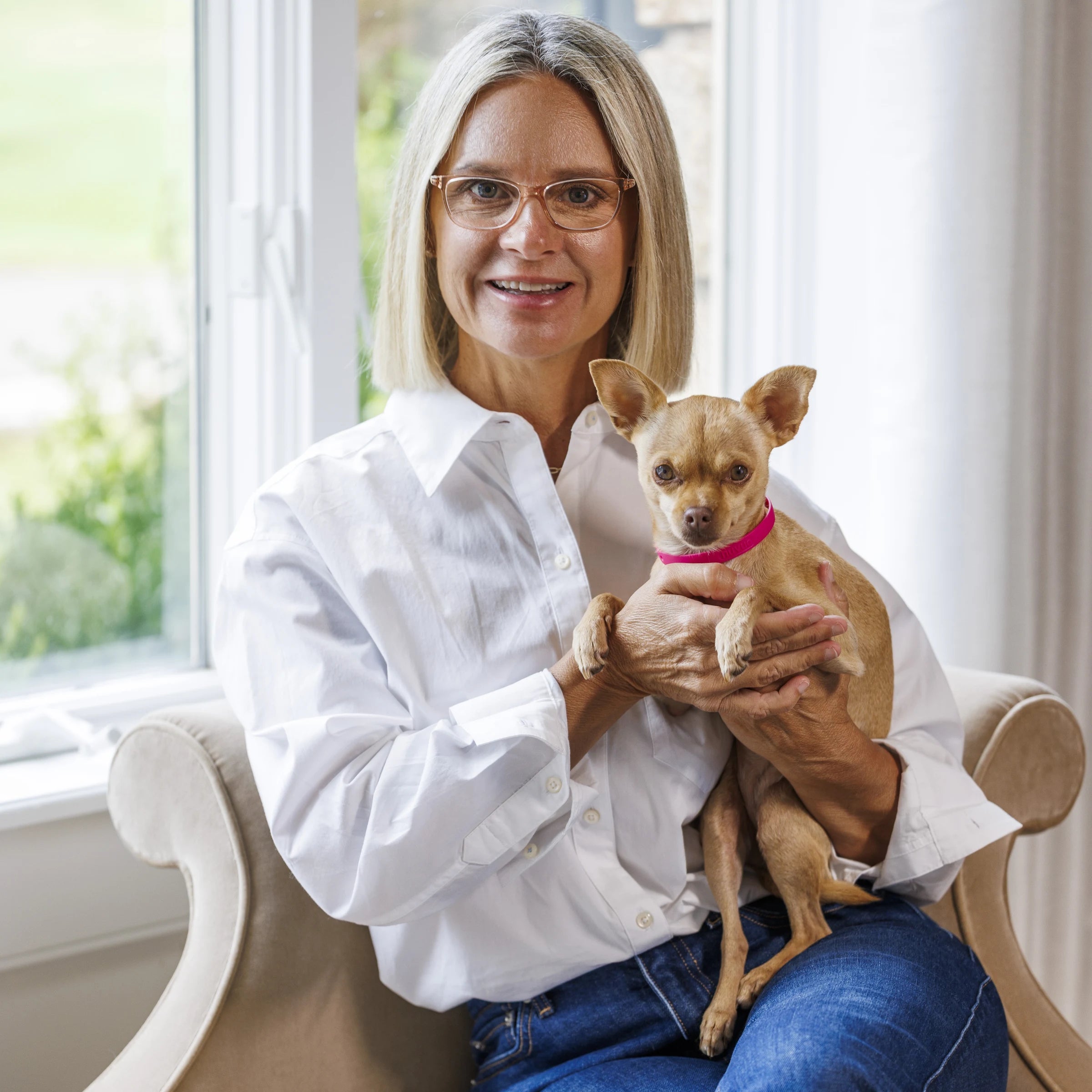 Heather Serianni, founder of TidiTurf, holding Porkchop